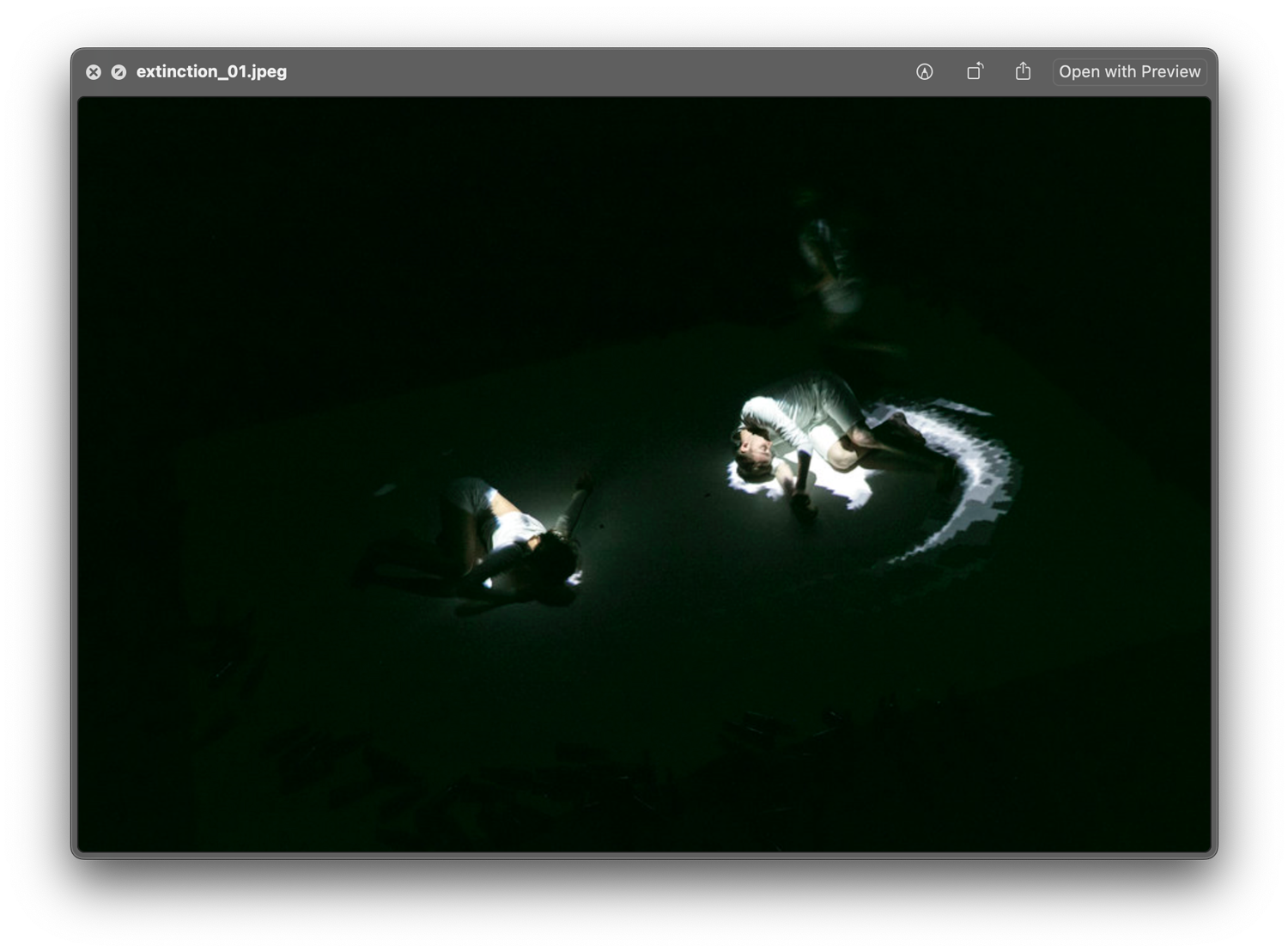 Dancers performing with the installation traces of light following them